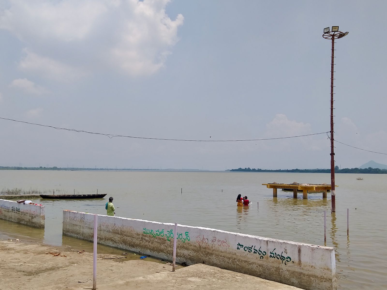 The Godavari river, wide and calm, seen from a riverside ghat at Manthani